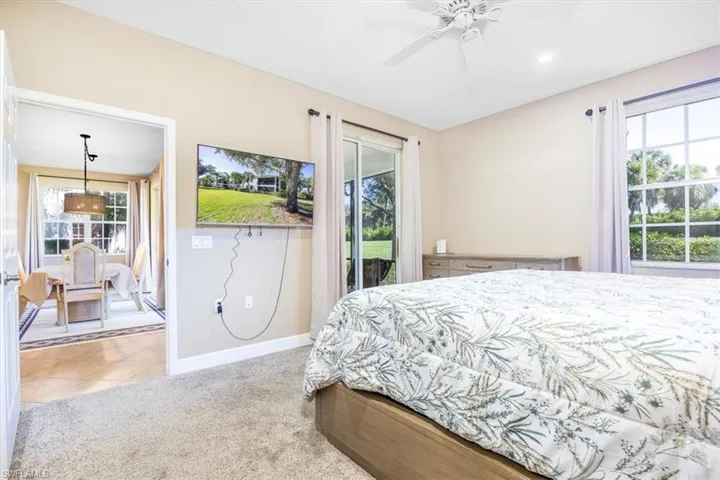 Bedroom featuring multiple windows, access to exterior, light colored carpet, ceiling fan, and recessed lighting
