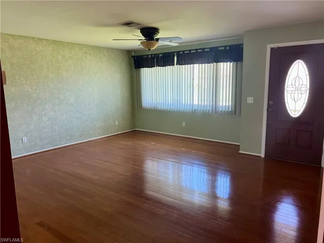 Entrance foyer featuring dark wood finished floors and ceiling fan