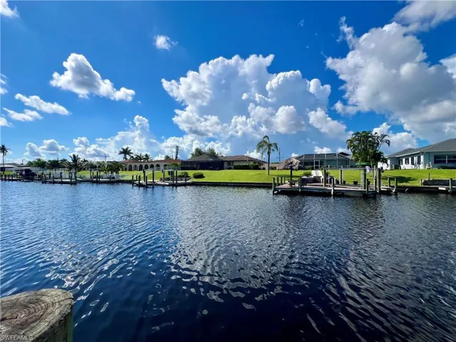 Water view with a dock and nearby suburban area