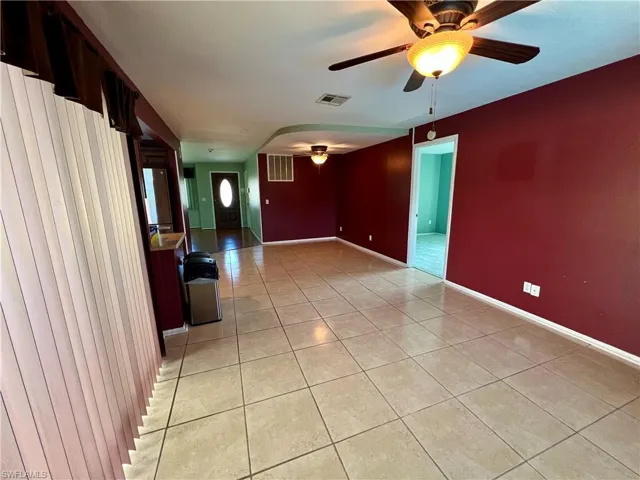 Spare room with ceiling fan and light tile patterned floors
