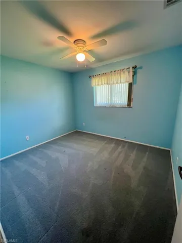 Empty room with carpet and baseboards