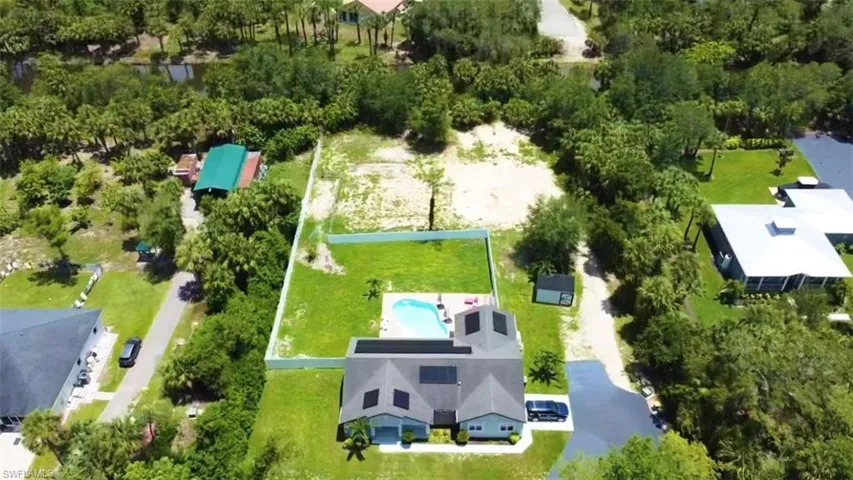 Aerial overview of property's location with property parcel outlined and a pool