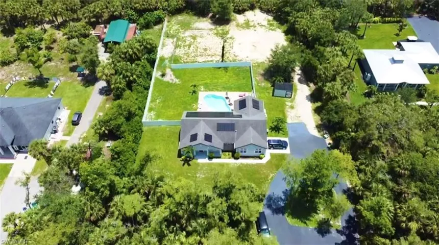 Aerial view of property's location with property parcel outlined and a pool