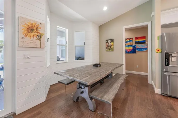 Dining area featuring recessed lighting, baseboards, lofted ceiling, and dark wood finished floors