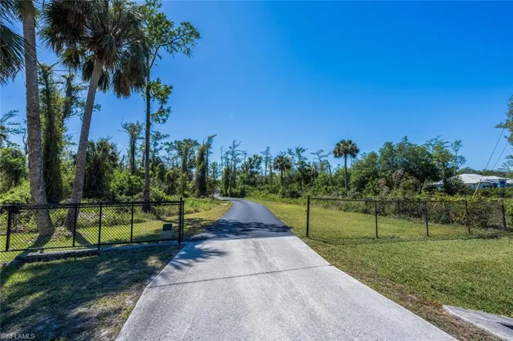 View of street with driveway and a gated entry
