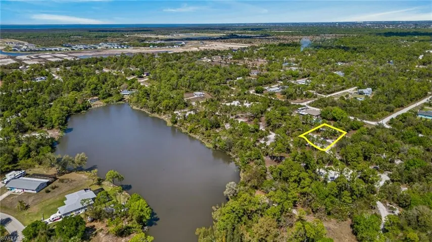 Aerial overview of property's location featuring a nearby body of water and property parcel outlined