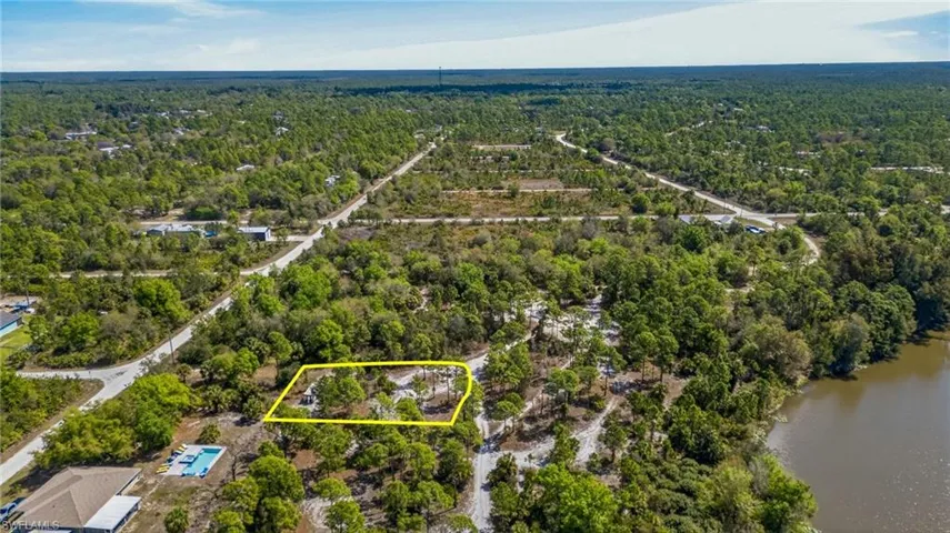 Aerial view of property's location featuring property parcel outlined and a large body of water
