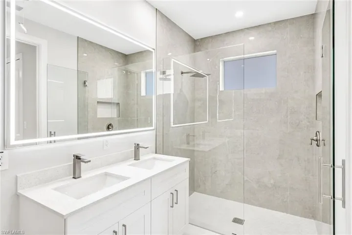 Bathroom with vanity and an enclosed shower