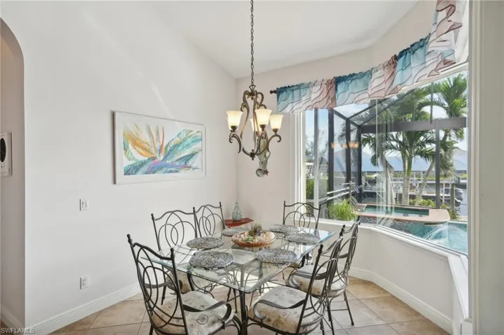 Dining room with a wealth of natural light and light tile patterned flooring
