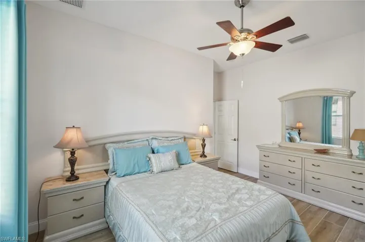 Bedroom with light hardwood / wood-style floors and ceiling fan