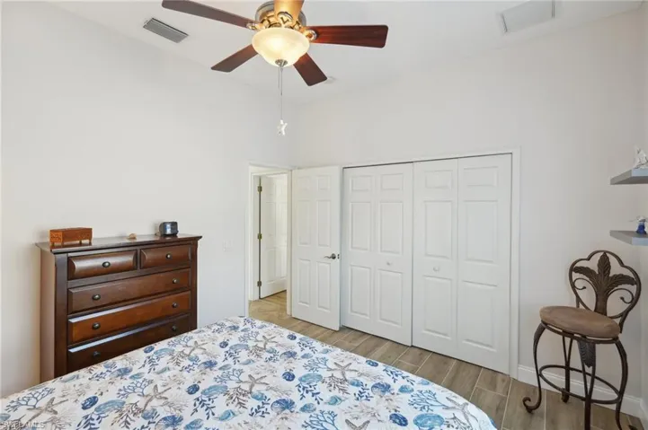 Bedroom featuring a closet, ceiling fan, and light hardwood / wood-style floors