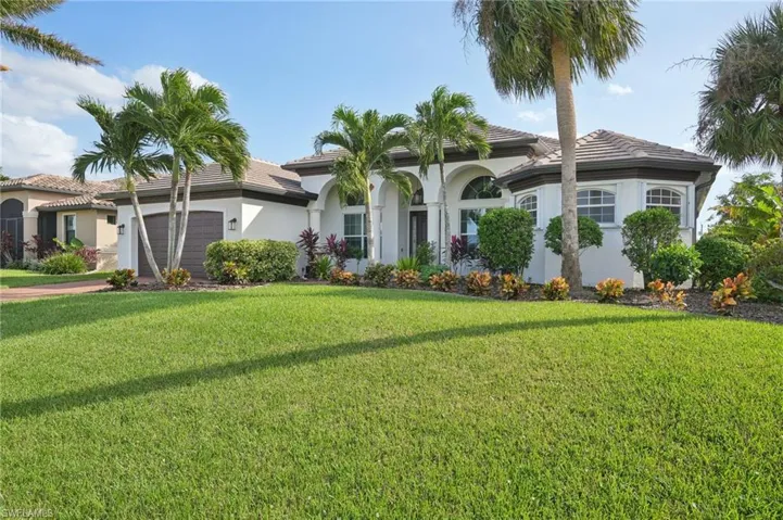 Mediterranean / spanish-style home with a front yard and a garage