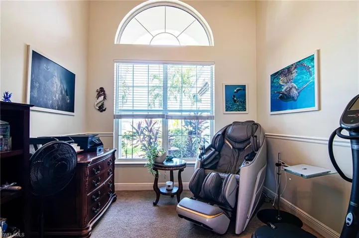 Office space featuring  a towering ceiling, and plenty of natural light