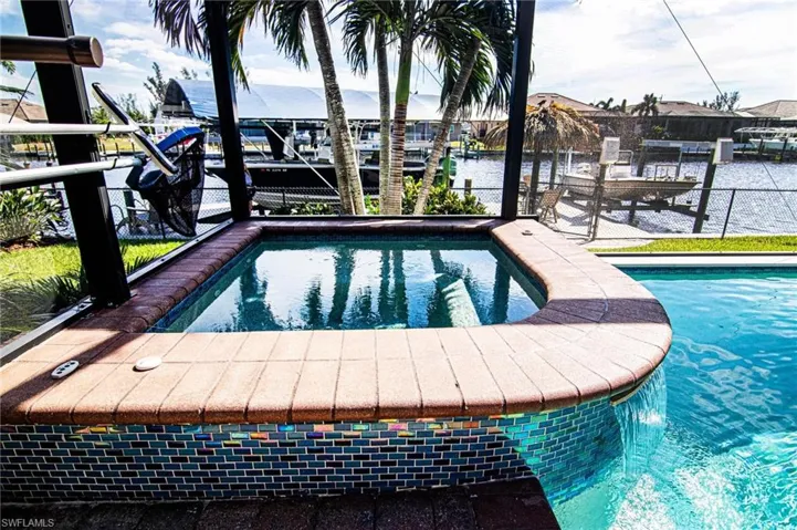View of swimming pool with a jacuzzi