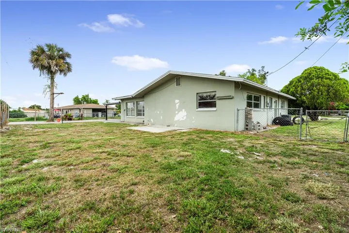 Back of house featuring a patio area and a lawn