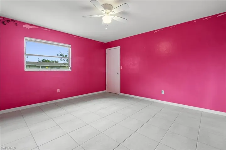 Empty room with tile floors and ceiling fan