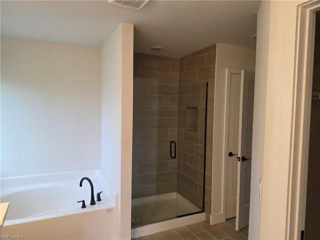 Contemporary bathroom featuring a walk-in shower with clear glass enclosure and built-in tile niche