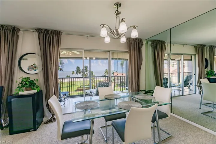Carpeted dining room featuring an inviting chandelier