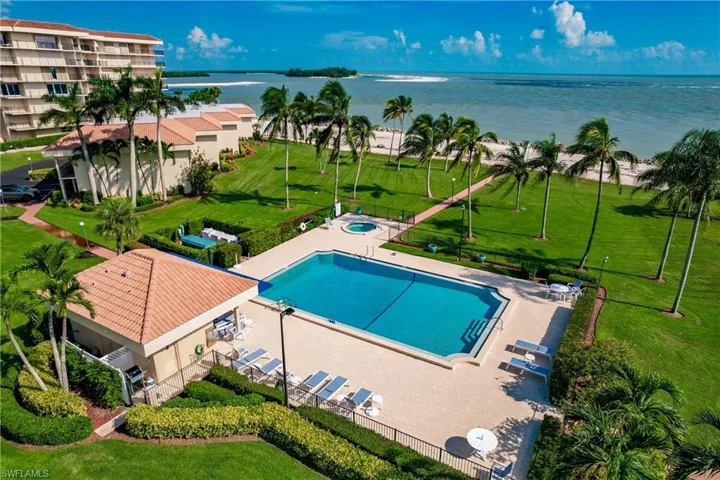 View of swimming pool with a yard and a water view