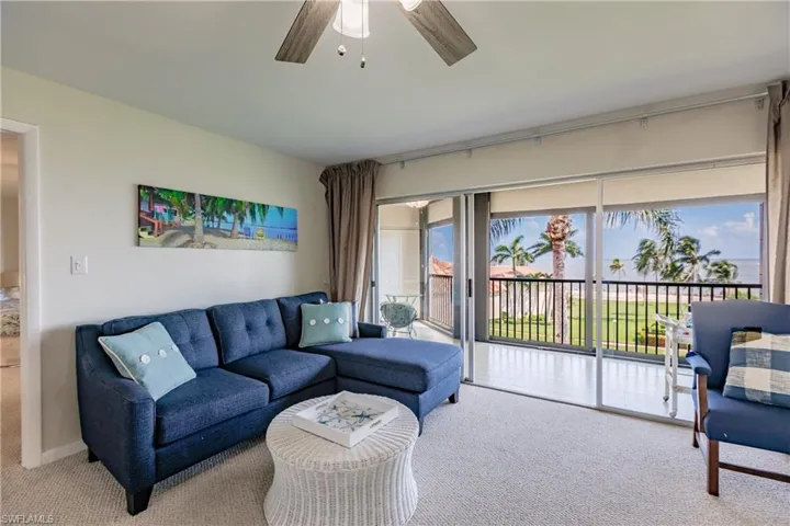 Living room with ceiling fan and carpet flooring