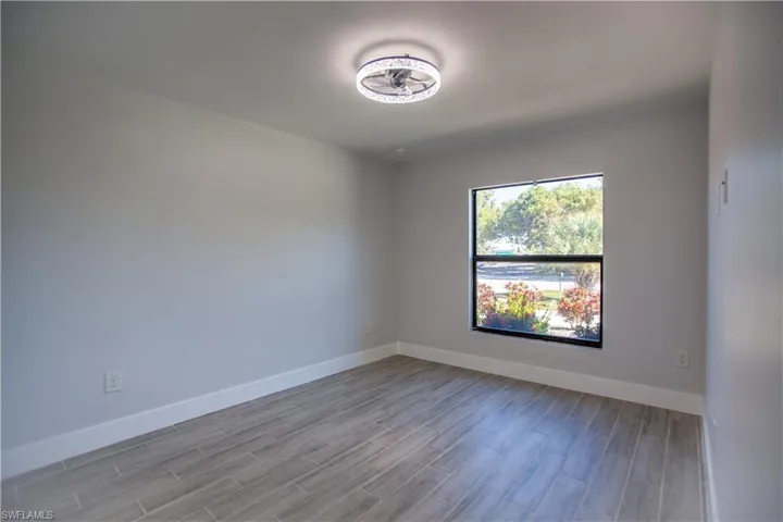 Spare room with baseboards and wood tiled floors