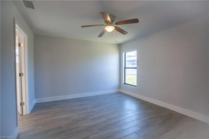 Unfurnished room with wood tiled floors and ceiling fan