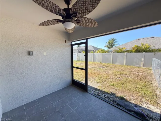 Unfurnished sunroom with ceiling fan