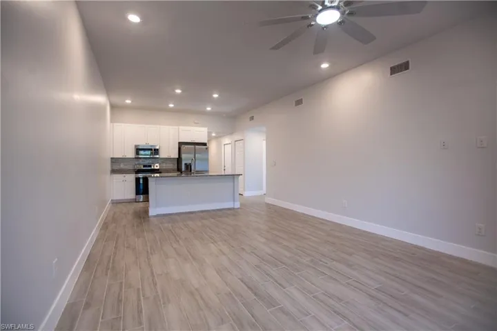 Unfurnished living room with recessed lighting, wood finish floors, and a ceiling fan