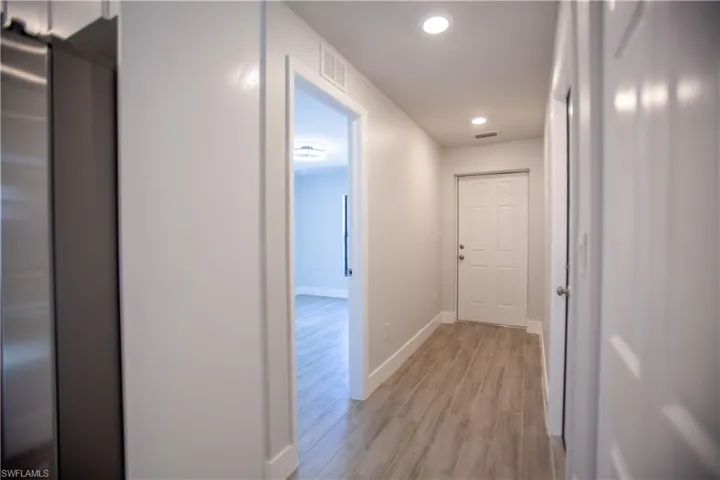 Hallway featuring wood tiled floors and recessed lighting