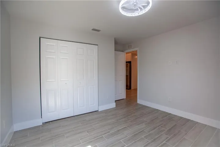 Unfurnished bedroom featuring a closet and wood tiled floors