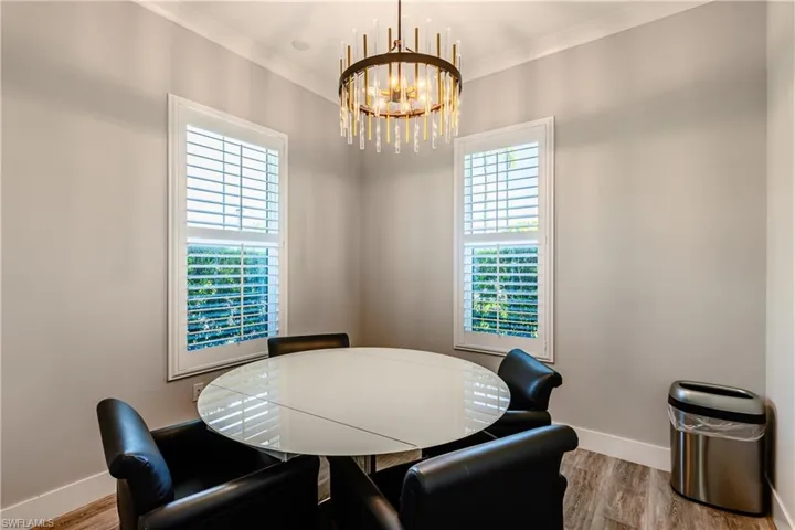 Community Dining room featuring a chandelier, ornamental molding, and light hardwood / wood-style floors