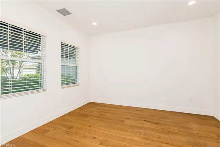 Den with light hardwood / wood-style floors