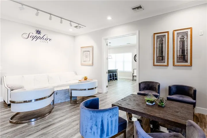 Community Living room featuring wood-type flooring and track lighting