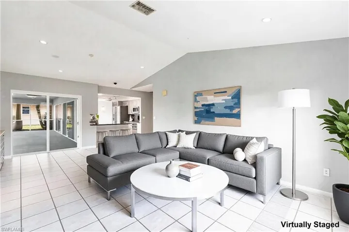 Family room virtually staged with pool table removed and furniture added