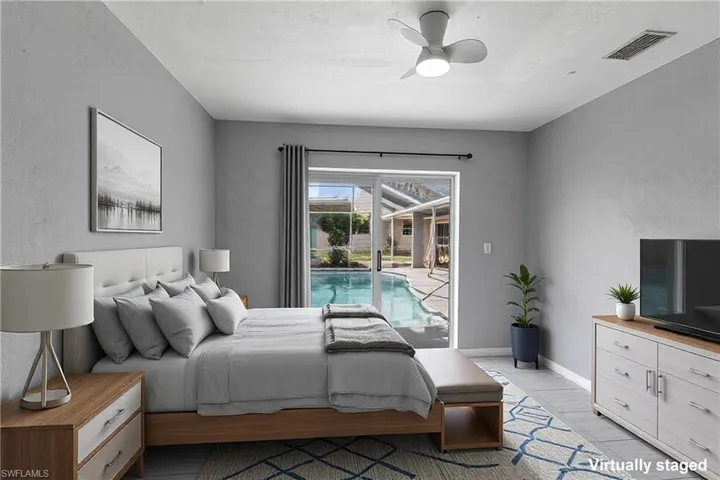 Bedroom 2 overlooking the pool.  Virtually staged image