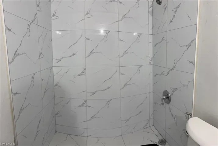 Bathroom featuring a shower and toilet