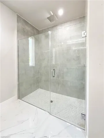 Bathroom featuring tile patterned flooring and walk in shower