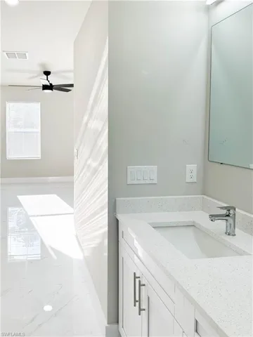 Bathroom featuring vanity and ceiling fan