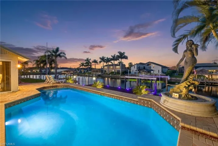 Outdoor pool with a water view and a patio