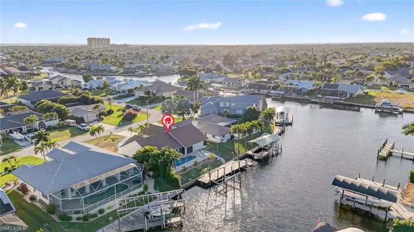 Aerial perspective of suburban area featuring a nearby body of water