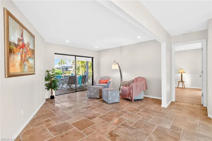 Sitting room with stone tile flooring and recessed lighting