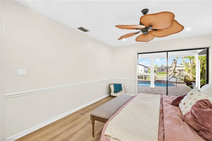 Bedroom featuring light wood finished floors, access to exterior, a ceiling fan, recessed lighting, and a sunroom