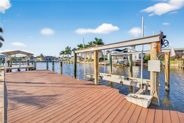 Dock area with a water view and boat lift