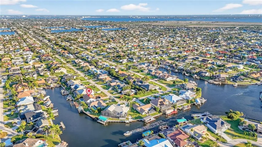 Aerial overview of property's location with nearby suburban area and a nearby body of water