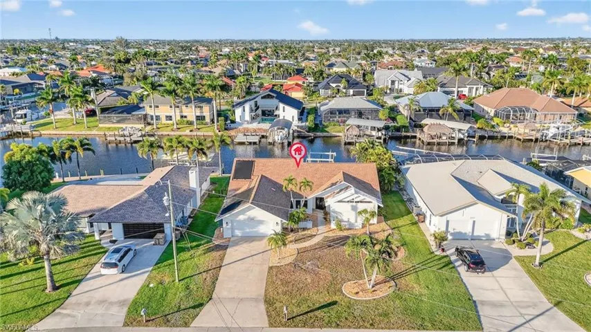 Aerial view of residential area featuring a large body of water