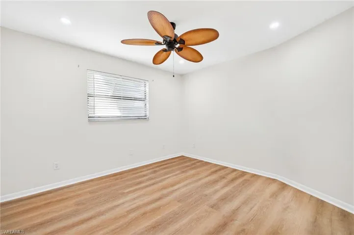 Empty room with wood finished floors, ceiling fan, and recessed lighting