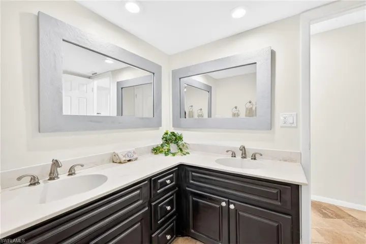 Bathroom with double vanity and recessed lighting