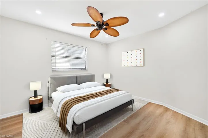 Bedroom with a ceiling fan, light wood-type flooring, and recessed lighting