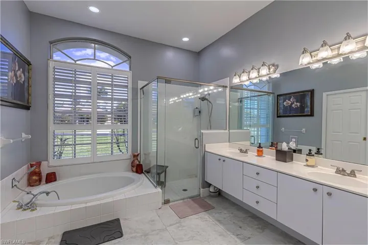 Primary Bathroom w/ vanity, shower stall & bathtub