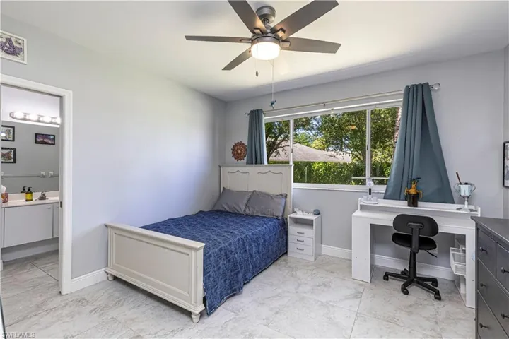 Guest Bedroom w/ desk, ceiling fan & ensuite bathroom